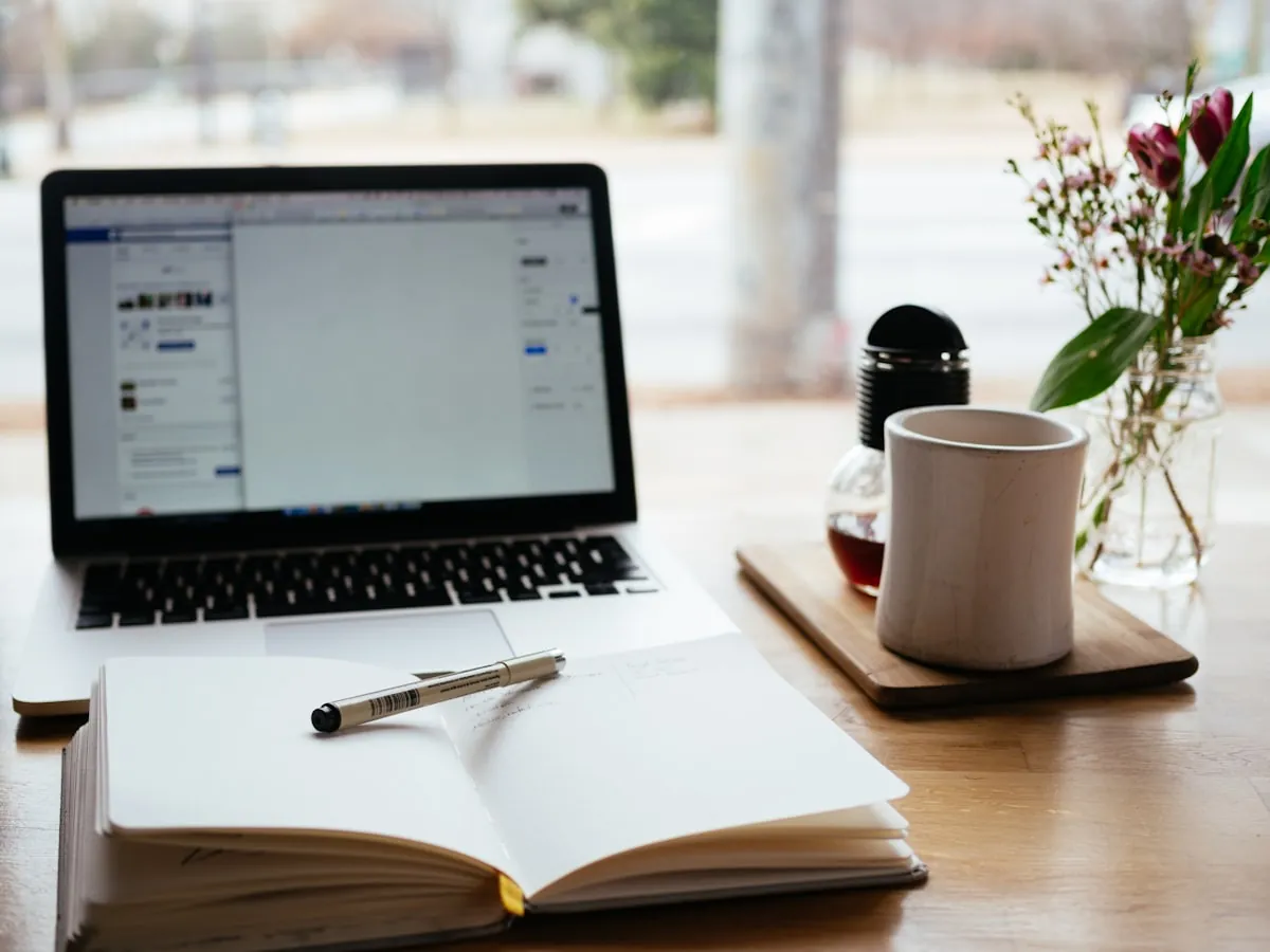 Online course creation workspace with laptop and notes
