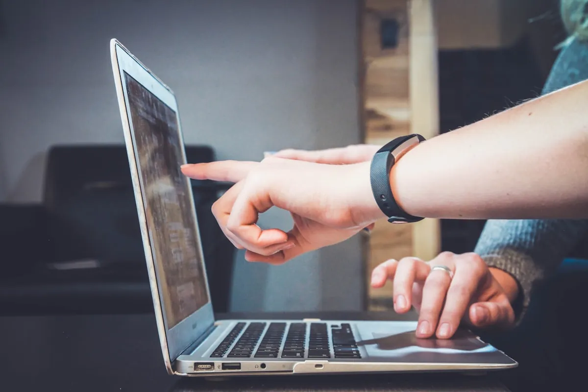 Remote worker thoughtfully composing a message on laptop