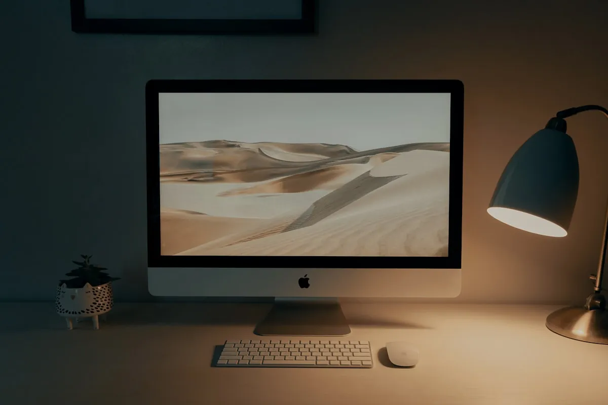 Monitor on desk with desk lamp in home office